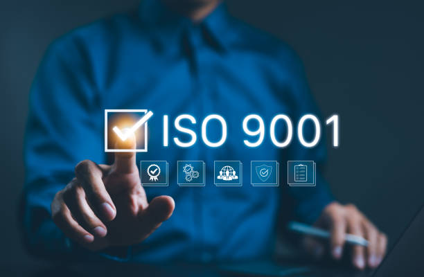 istock ISO 9001 Certification Concept. Businessman points to ISO 9001 with checkmark icons and quality control symbols, certification, and standardization in quality management. standard quality, certificate 2183947534