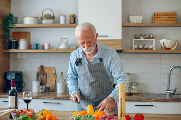 istock Happy retired senior man cooking in kitchen 2183948479