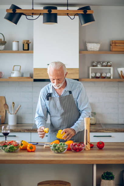 istock Happy retired senior man cooking in kitchen 2183948492