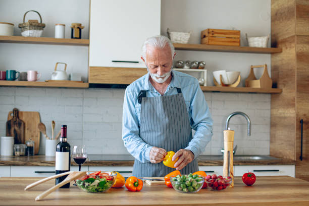 istock Happy retired senior man cooking in kitchen 2183948594
