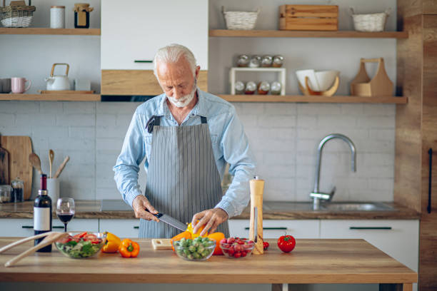 istock Happy retired senior man cooking in kitchen 2183950273