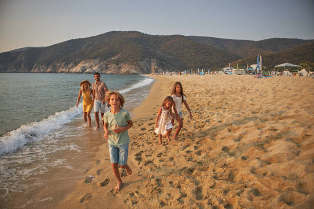 istock A family walks hand in hand down a tropical paradise beach during sunset 2183951056