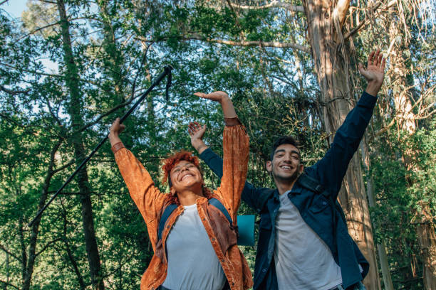 istock happy young people enjoying trip or excursion outdoors 2183955228