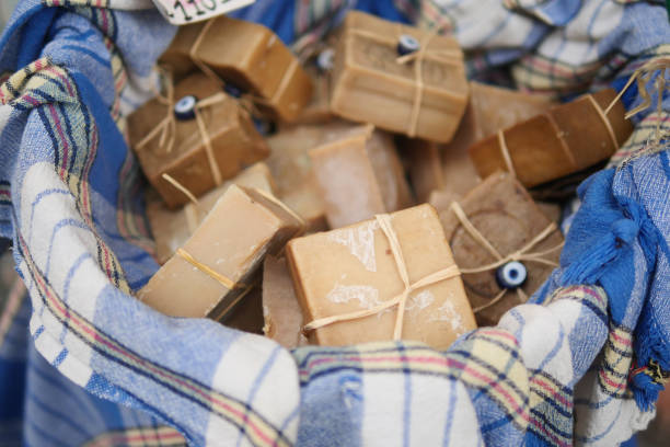 A charming collection of artisanal soaps lovingly nestled within a vibrant, colorful fabric basket