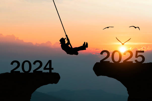 istock Silhouette Happy New Year 2025 People Jumping Over Cliffs 2183956620