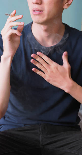 istock man smokes discomfort lungs throat 2183959265
