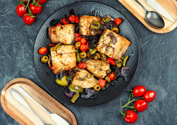 istock Fish fillet and baked vegetables on a plate. 2183960398