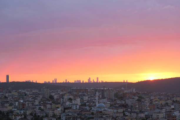 A breathtaking sunset paints the sky over a city skyline, showcasing urban beauty.
