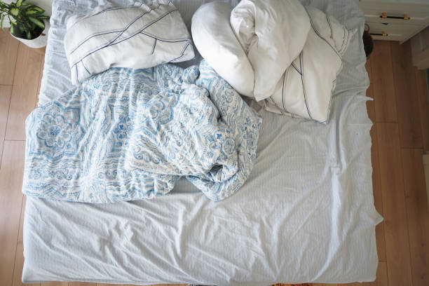 istock messy bed in early morning , messy bed after waking up 2183963630