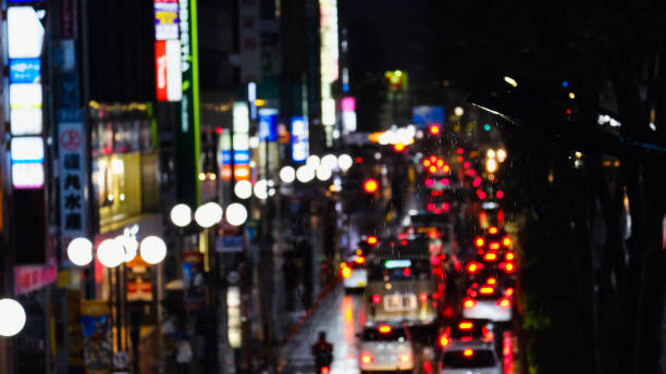 istock Rainy Night Traffic and Neon Lights in a Bustling City 2183963692