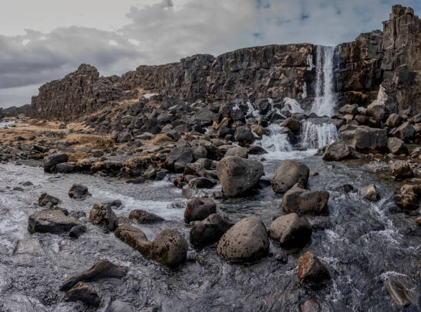 þingvellir National Park is a part of the Golden Circle of Iceland. Situated on the north shore of Lake Thingvallavatn, it's only 30 miles east of Reykjavik on April 13, 2024. Walking between two tectonic plates. Oxararfoss waterfall in winter.