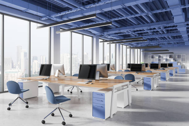 istock Blue office coworking interior with desks and computers in row, panoramic window 2183968268
