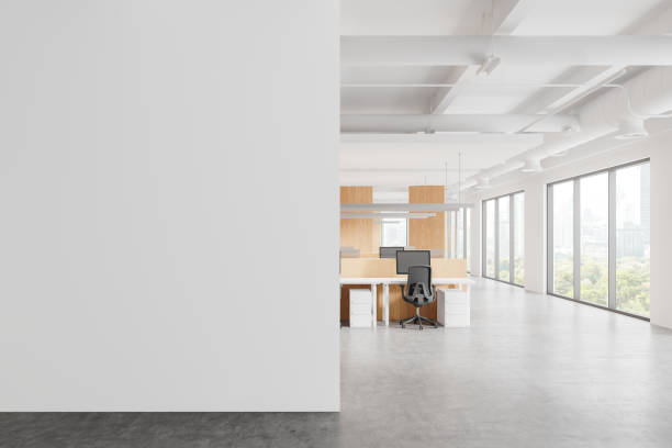 istock Office coworking interior with pc monitors in row, window. Mockup wall 2183968740