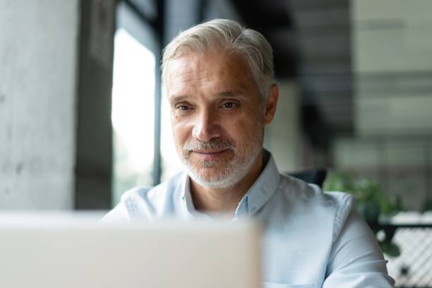 istock Mature 40s focused businessman, executive director working using laptop sitting at office 2183968928