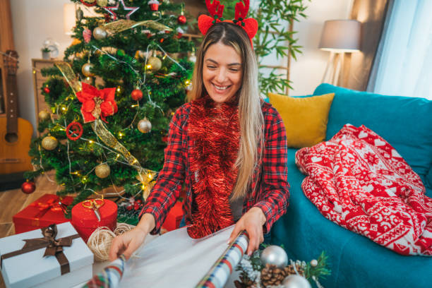istock Young woman preparing Christmas presents 2183973441