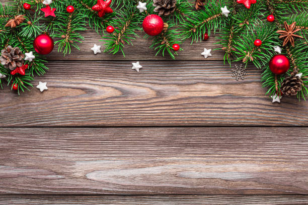istock Christmas background with fir tree branches, red decorations and pine cones on rustic wooden table. Flat lay. Happy New Year and winter holidays layout. Top view with copy space 2183973798