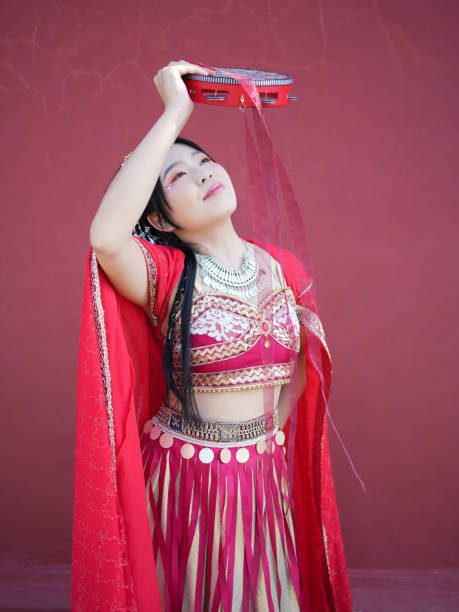 Kashgar, China - June 1, 2024: Uygur dancers were playing on the stage with trational music in the park.