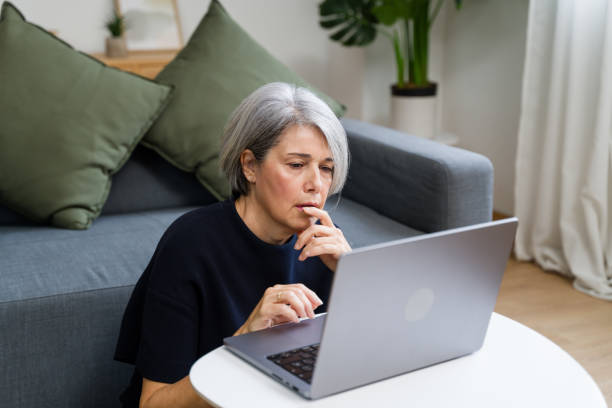 istock Focused senior woman working from home on laptop is thinking and browsing internet 2183975077