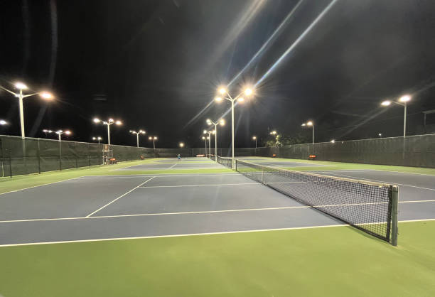 istock Illuminated tennis courts at night 2183976475