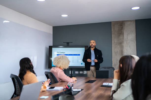 istock CEO/Director talking with employees/coworkers at office 2183977524