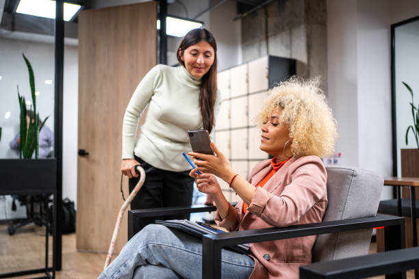Female coworkers talking at office lobby