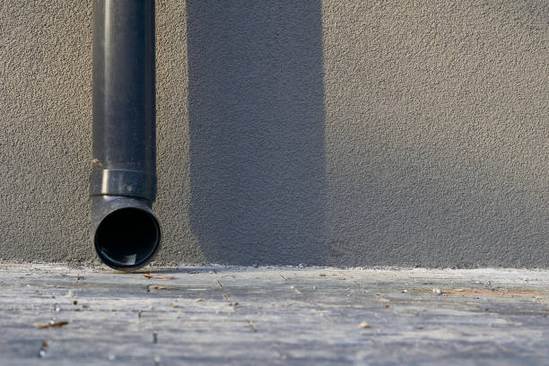 istock Rain runoff.New plastic drain pipe on a gray plastered wall 2183980016