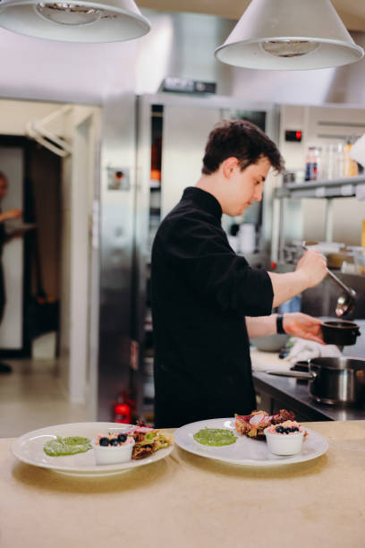 istock Chef Cooking and Swerving Dinner at Modern Restaurant 2183981437
