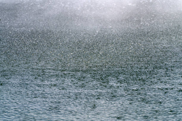 The rain falls on the surface of the pond and makes a weir.