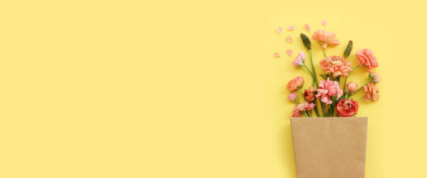 istock Top view image of pink flowers composition over yellow background 2183981607