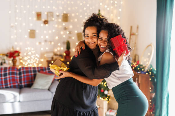 istock Girlfriends hugging after exchanging Christmas presents 2183981942