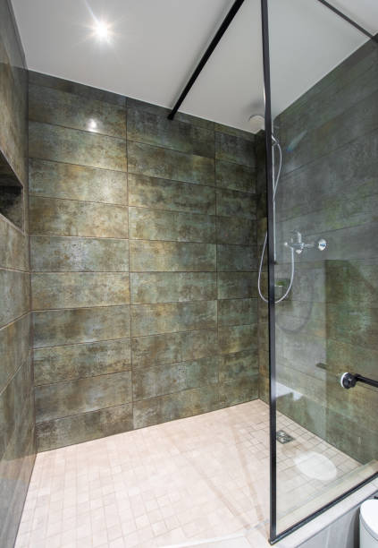 Bright Elegant Modern Luxury Home Bathroom Interior Design With Marble Tiled Wall. LED Lights. Shower Area, Tile Floor. Modern Loft. Wide Angle