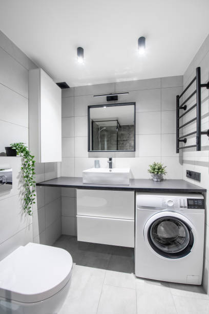 istock Bright Elegant Modern Luxury Loft Home Bathroom Interior Design With White Sink. Tiled Gray Walls, Mirror and Faucet. LED Lights. Shower Area, Heater, Laundry Machine 2183982871