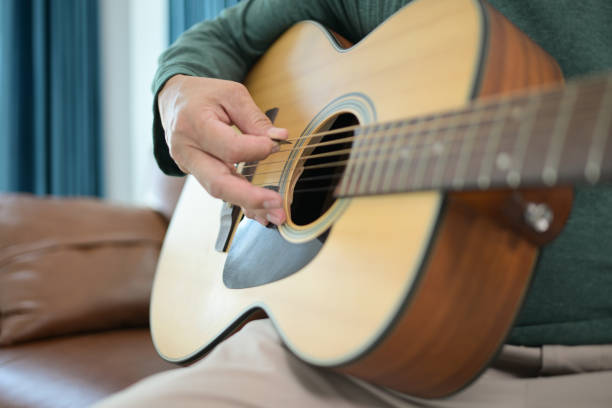 istock Senior man plays music at home 2183983070
