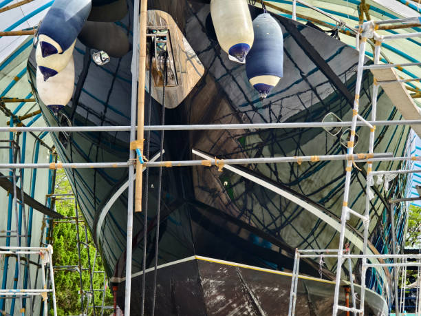 istock A boat is carefully lifted under a covered structure 2183987534