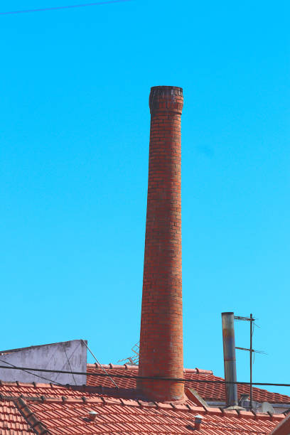 Very tall orange brick chimney
