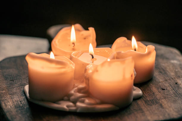 istock Wax candles burning on a wooden board or table 2183989852
