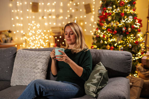 istock Woman enjoys tea during Christmas Eve 2183995014