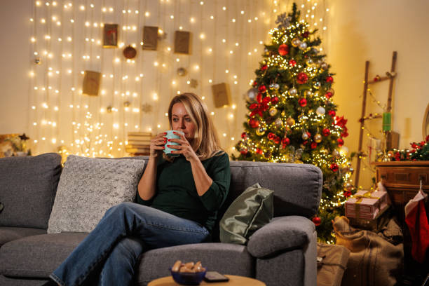 istock Woman enjoys tea during Christmas Eve 2183995059