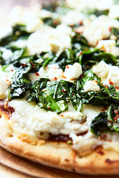 istock Pizza with mozzarella cheese and spinach. Dark wooden background. Close up. 2183997148