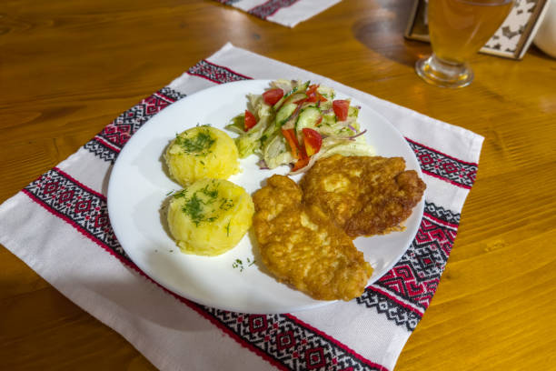 Roasted boneless pork chops with mashed potatoes and vegetables salad