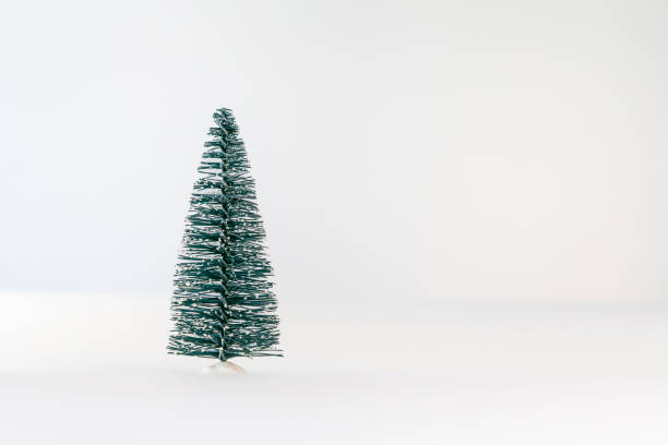 istock Small, artificial, green Christmas tree on a white background. Christmas and New Year concept. 2184000917