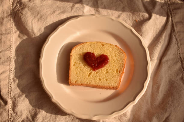 Toast with a jam heart on it on a plate