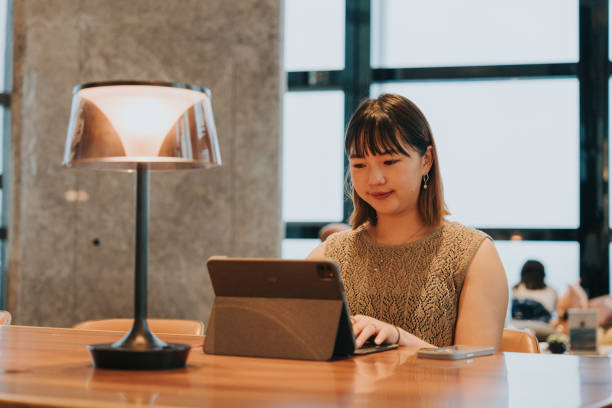 istock Asian chiense  girl working witha latpop  and seeking for advice from AI assistant on a mobile app 2184006596
