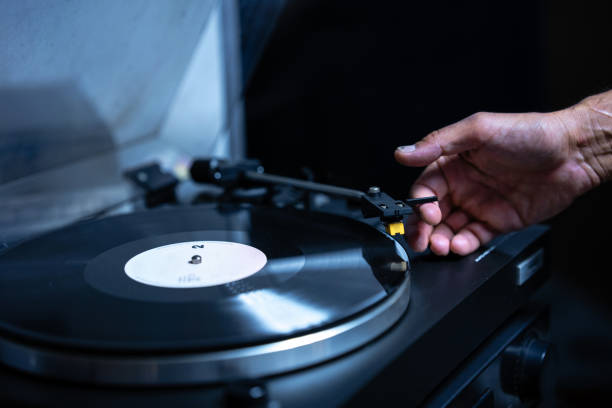 istock Close-up of a man playing vinyl on turntable record player 2184006676