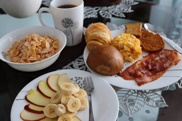 A plate with a small breakfast and a cappuccino served in a cafe. Shallow depth of field.