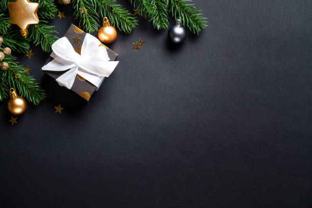 istock Black christmas background. Christmas present with golden decorations 2184013751