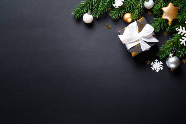 istock Black christmas background. Christmas present with golden decorations 2184013780