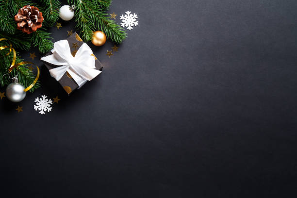 istock Black christmas background. Christmas present with golden decorations 2184013800