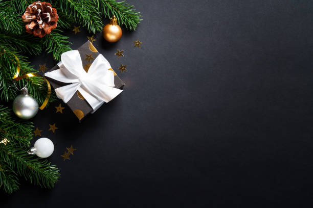 istock Black christmas background. Christmas present with golden decorations 2184013810