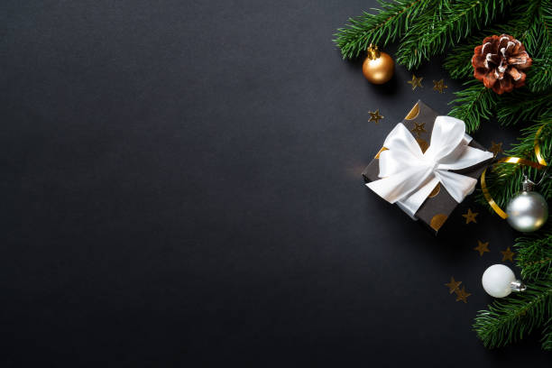 istock Black christmas background. Christmas present with golden decorations 2184013817